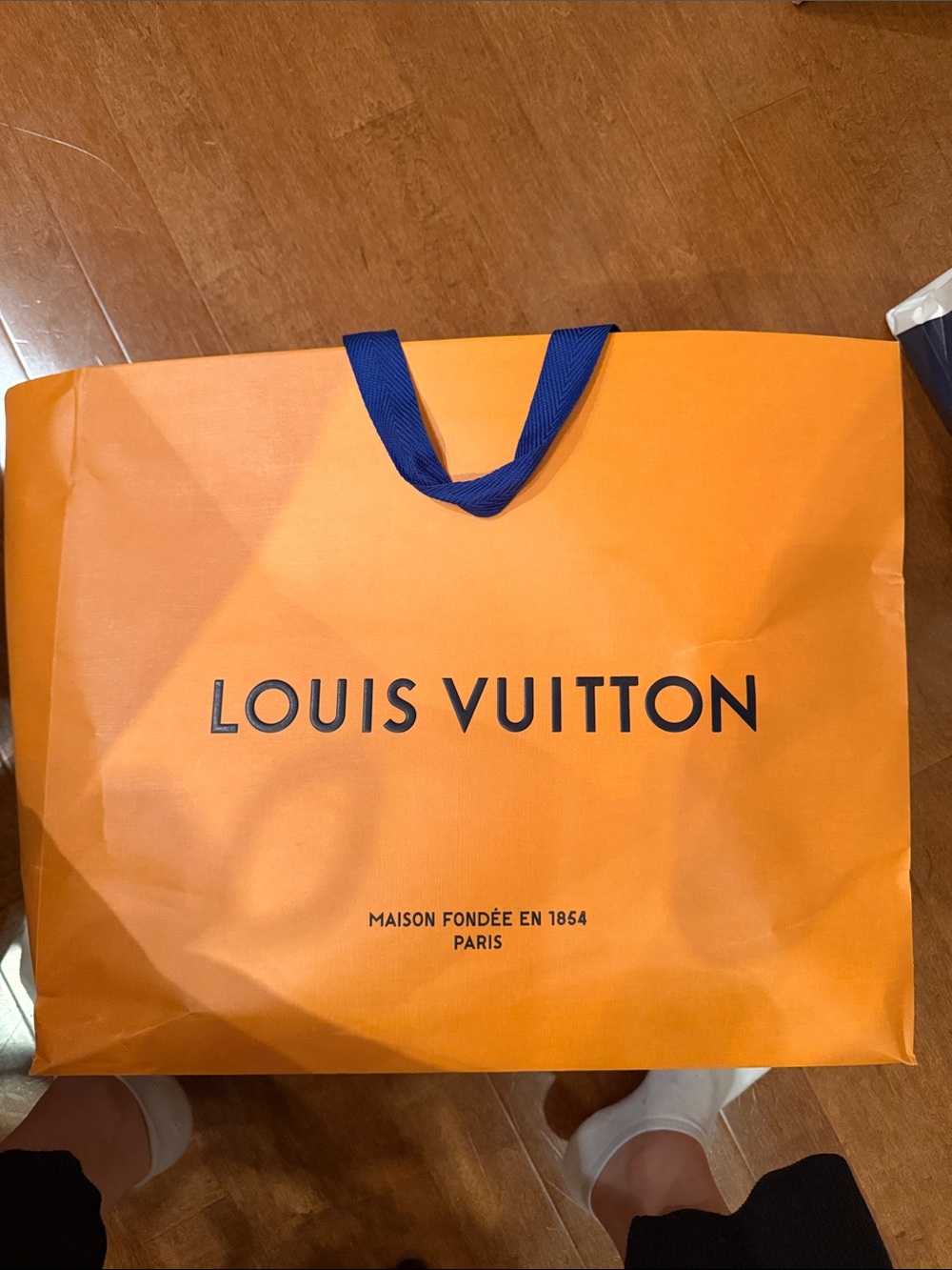 Louis Vuitton Orange Shopping Bag with Blue Handles and Black Logo